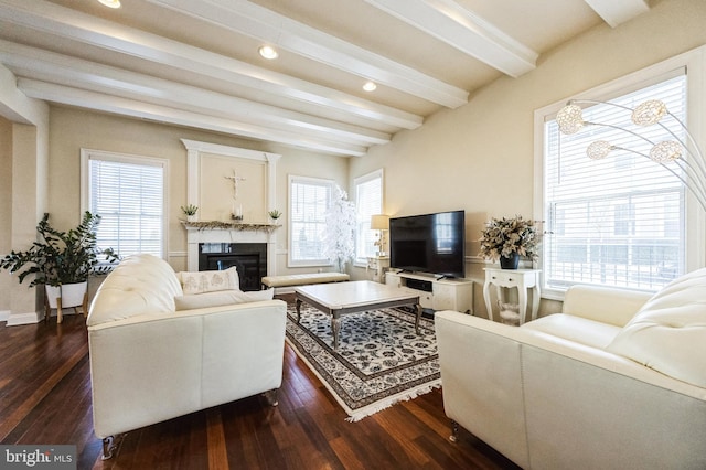 living room with recessed lighting, dark wood finished floors, beam ceiling, and a glass covered fireplace