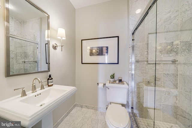 full bath with marble finish floor, toilet, a stall shower, a sink, and baseboards