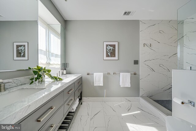 bathroom featuring a sink, visible vents, marble finish floor, a marble finish shower, and double vanity