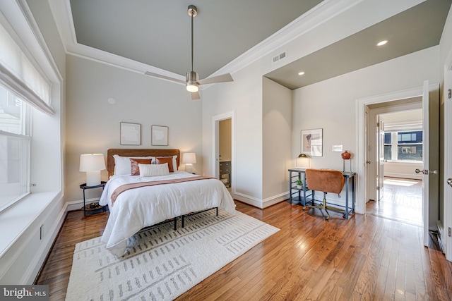 bedroom with visible vents, baseboards, wood-type flooring, ornamental molding, and recessed lighting