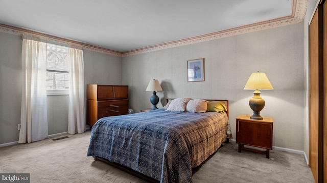 bedroom with light carpet, visible vents, and baseboards