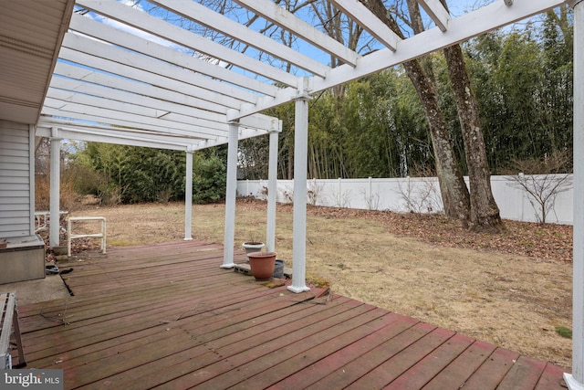 deck with a fenced backyard, a lawn, and a pergola