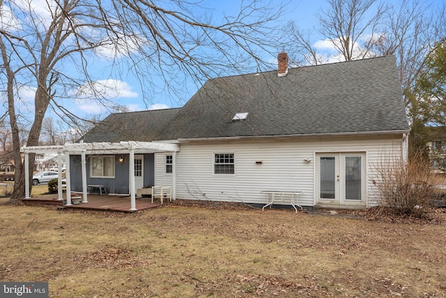 rear view of property with a shingled roof, a lawn, a chimney, french doors, and a pergola