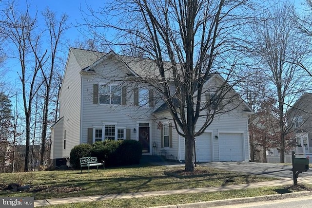 view of front of house with a garage, driveway, and a front lawn