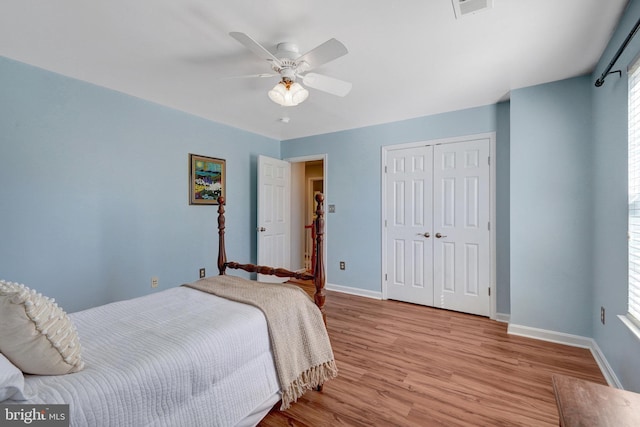 bedroom with a closet, baseboards, ceiling fan, and light wood finished floors