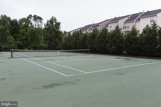 view of tennis court with fence