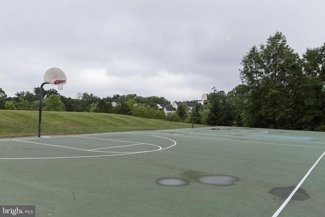 view of sport court featuring community basketball court and a lawn