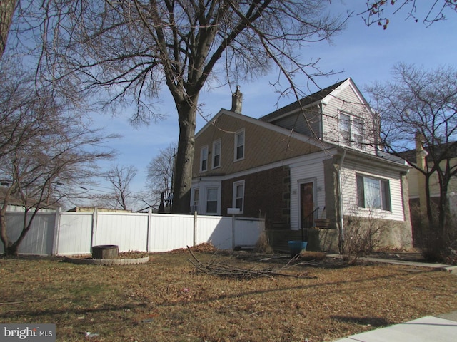 view of side of home with fence