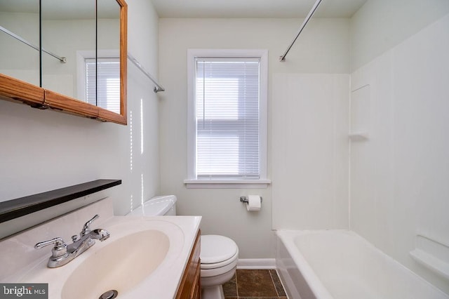 bathroom featuring shower / washtub combination, a healthy amount of sunlight, vanity, and toilet