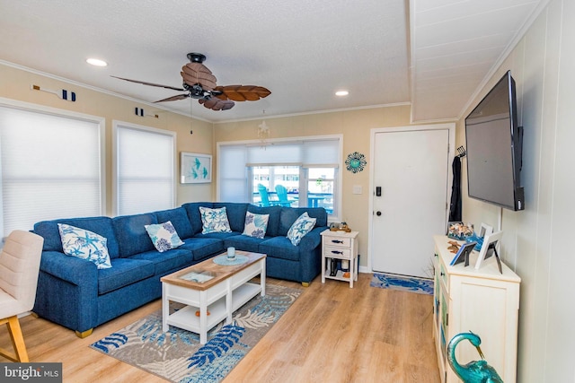 living area with ornamental molding, a ceiling fan, recessed lighting, and wood finished floors