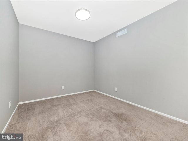 unfurnished room with baseboards, visible vents, and carpet flooring