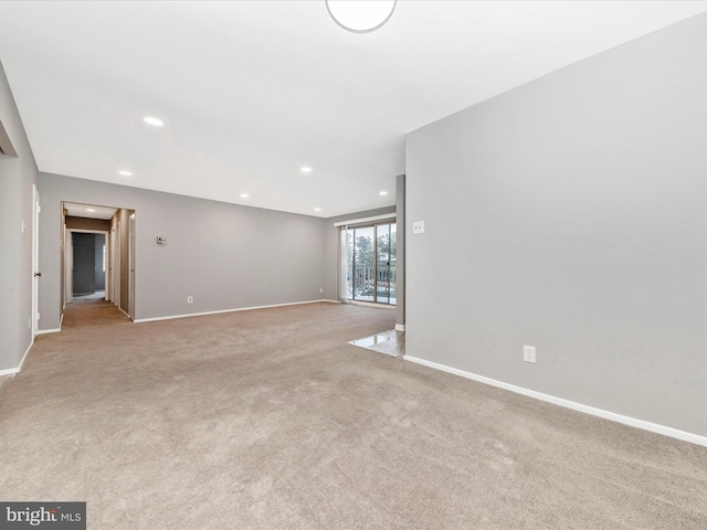 carpeted spare room featuring recessed lighting and baseboards