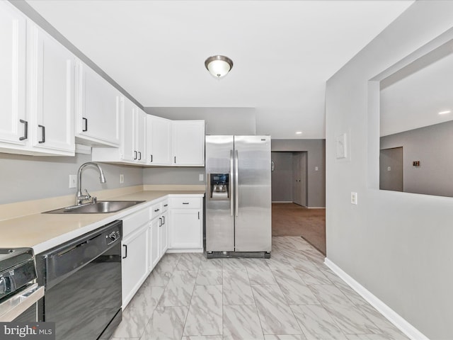 kitchen featuring a sink, stainless steel fridge, white cabinetry, and dishwasher