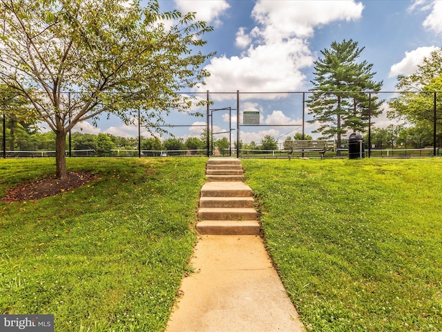 view of home's community featuring a yard and fence