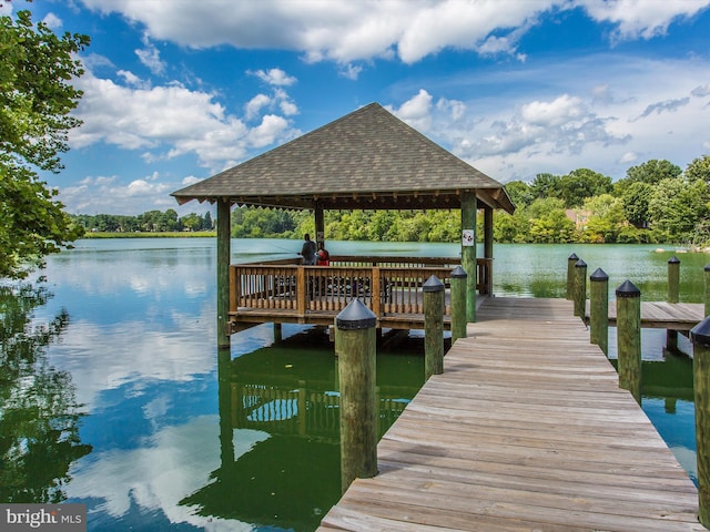 view of dock featuring a gazebo and a water view