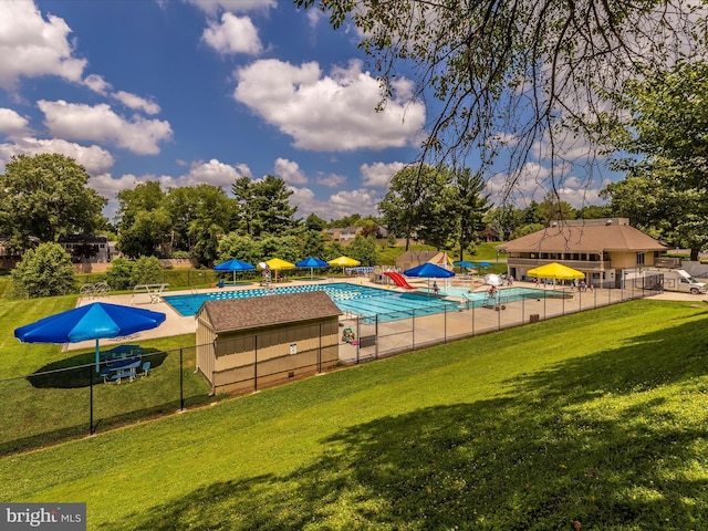 pool featuring a yard and fence