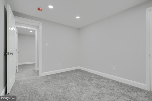 carpeted empty room featuring baseboards and recessed lighting