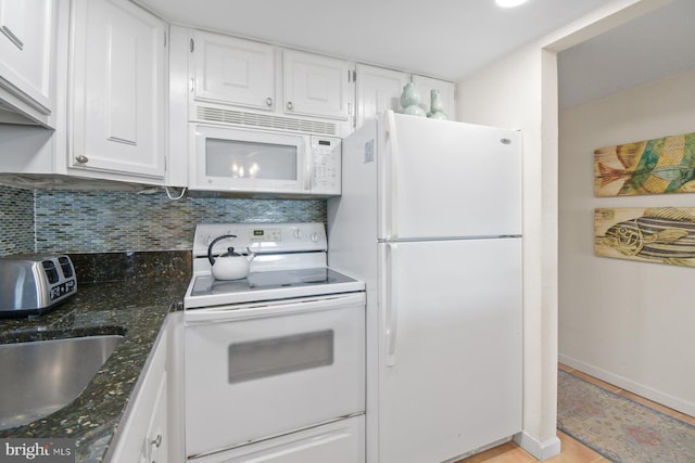 kitchen featuring white appliances, white cabinetry, and decorative backsplash