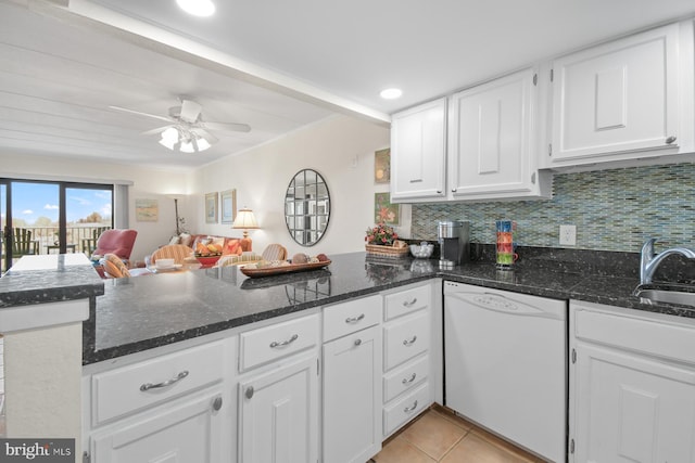 kitchen with backsplash, white cabinets, white dishwasher, and a peninsula