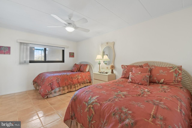 bedroom featuring ceiling fan, baseboards, and tile patterned floors