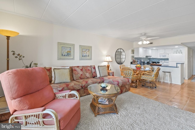 living area featuring ceiling fan and light tile patterned floors