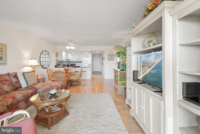 living room with a ceiling fan and light tile patterned flooring