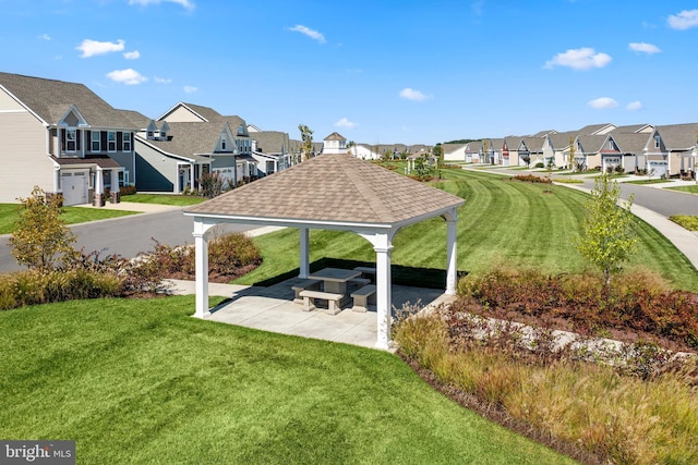 view of community featuring a gazebo, a lawn, a patio, and a residential view