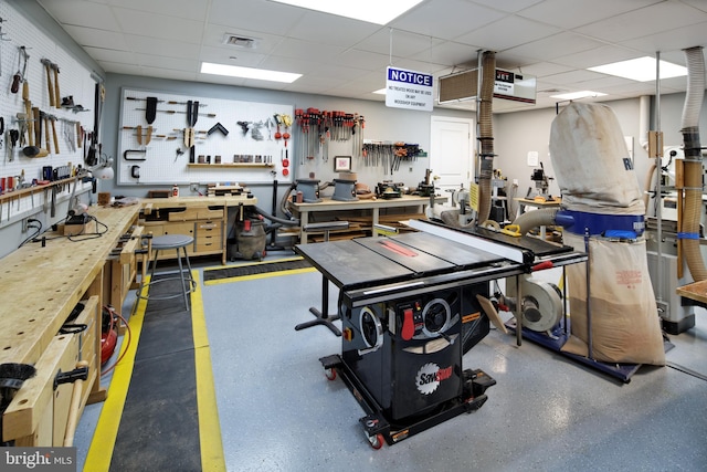 garage featuring a workshop area and visible vents