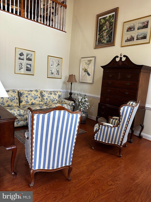 living area featuring baseboards and wood finished floors