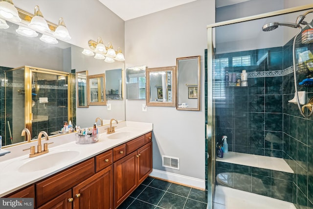 bathroom with tile patterned floors, visible vents, a stall shower, and a sink