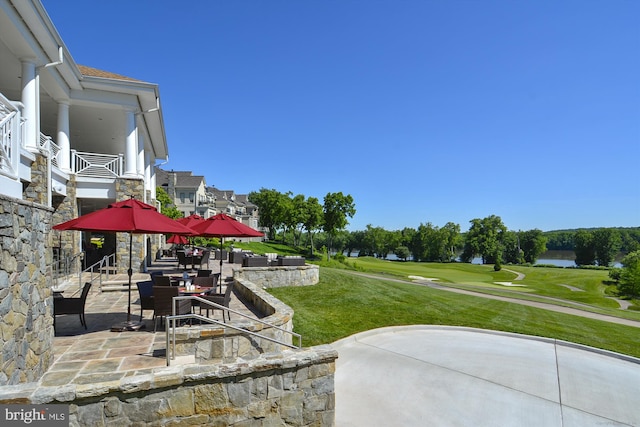 view of yard featuring a patio and view of golf course