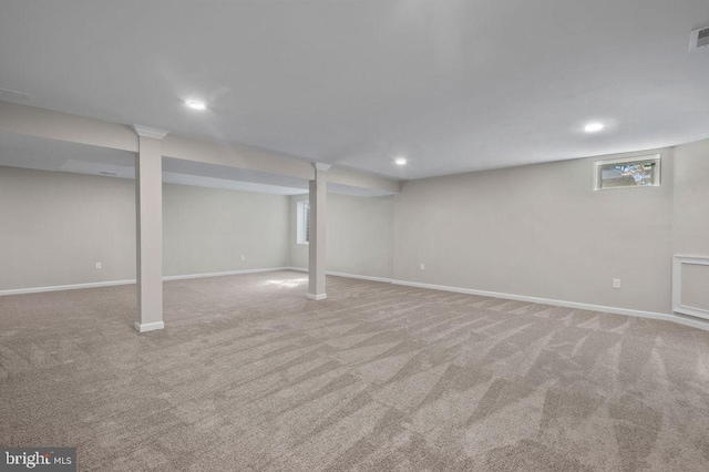 basement with baseboards, visible vents, light colored carpet, and recessed lighting