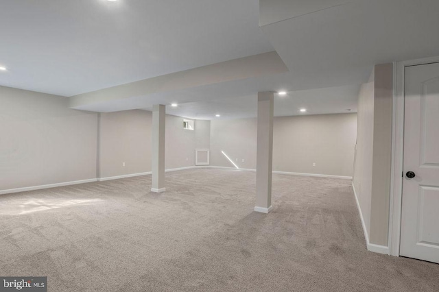 finished basement with recessed lighting, light colored carpet, and baseboards