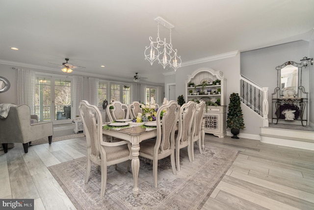 dining room with light wood-style floors, crown molding, and stairs