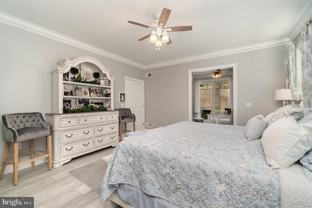 bedroom featuring light wood-type flooring, visible vents, ornamental molding, and a ceiling fan