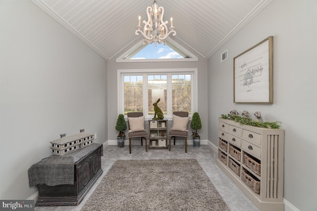 living area with a chandelier, vaulted ceiling, and baseboards