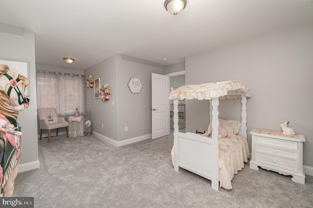 bedroom featuring light carpet and baseboards