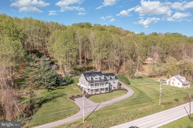 drone / aerial view featuring a forest view