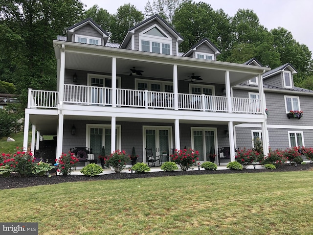 view of front of home with a porch, a front lawn, a balcony, and a ceiling fan