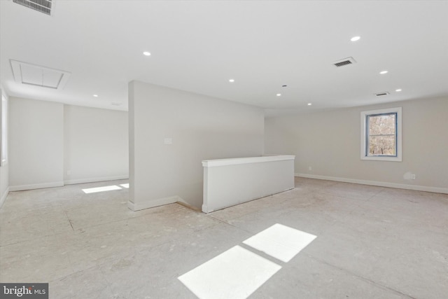 empty room with attic access, visible vents, baseboards, and recessed lighting