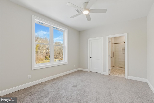 unfurnished bedroom featuring light carpet, ceiling fan, ensuite bath, and baseboards