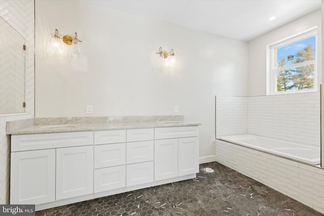 bathroom with vanity and a bath