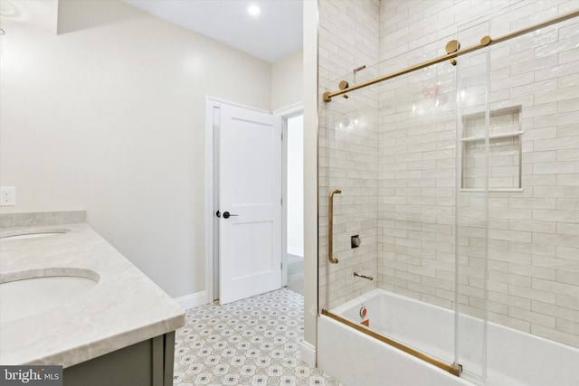 full bath featuring double vanity, combined bath / shower with glass door, a sink, and tile patterned floors