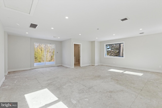 unfurnished room with attic access, visible vents, baseboards, and recessed lighting