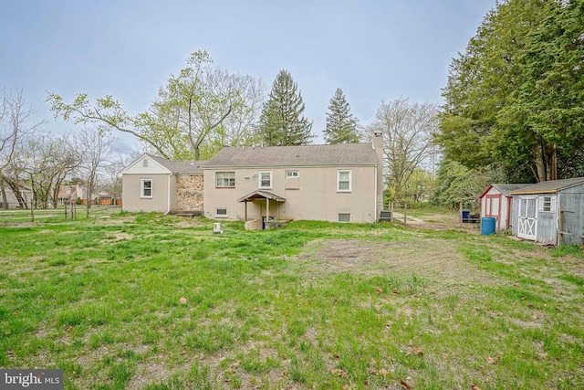 508 Garden Way, Mount Laurel, NJ 08054 - back of property with a chimney, fence, a storage shed, an outbuilding, and a lawn