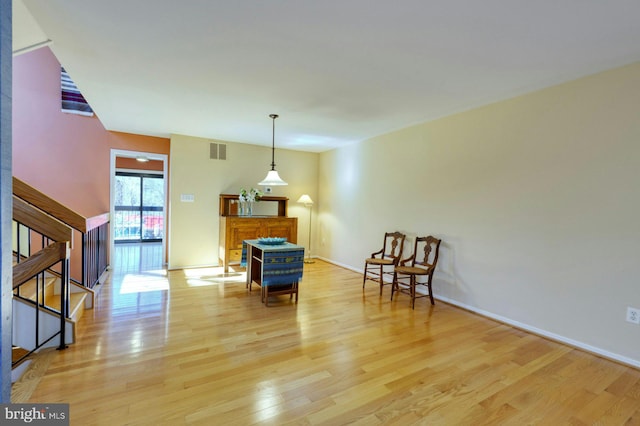 sitting room with visible vents, stairway, baseboards, and light wood-style floors