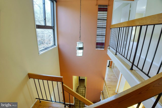 staircase featuring a towering ceiling