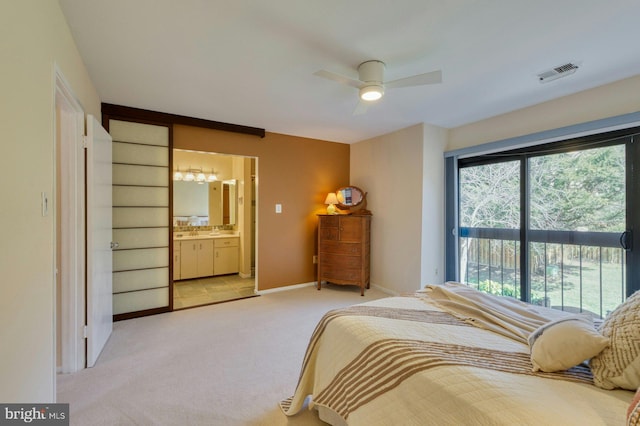 bedroom featuring carpet, visible vents, baseboards, access to exterior, and ensuite bathroom