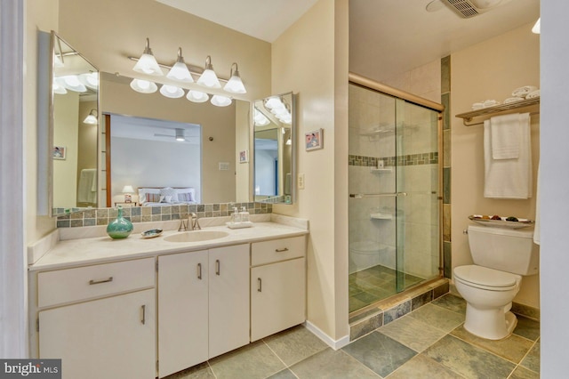 bathroom with tasteful backsplash, a shower stall, toilet, and vanity