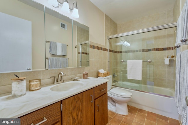 full bath with tile patterned floors, visible vents, toilet, enclosed tub / shower combo, and vanity